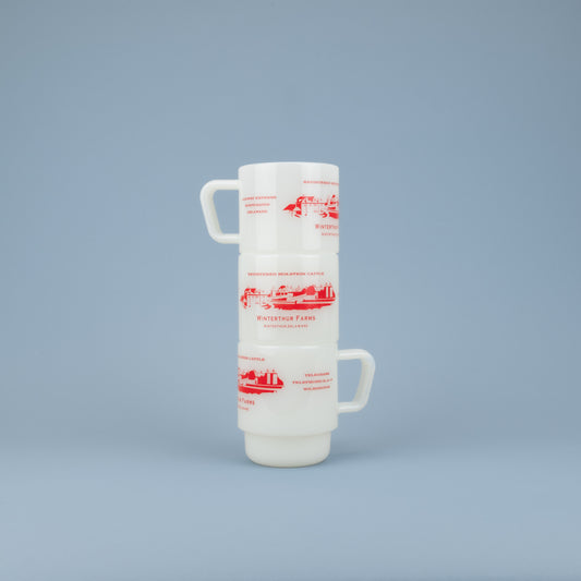 Three stacking white glass mugs with the words 'REGISTERED HOLSTEIN CATTLE' in red above a red barn graphic with "WINTERTHUR FARMS - WINTERTHUR, DELAWARE' in red below against a blue background